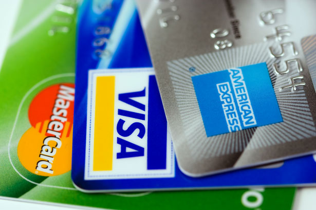 Three credit cards Visa Mastercard and American Express close up on logos